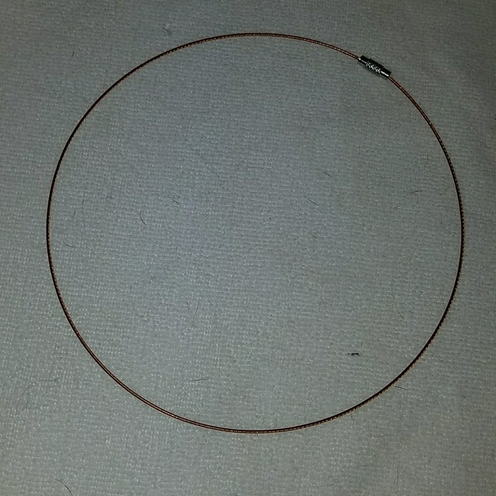 Brown twisted wire choker with silver closure.